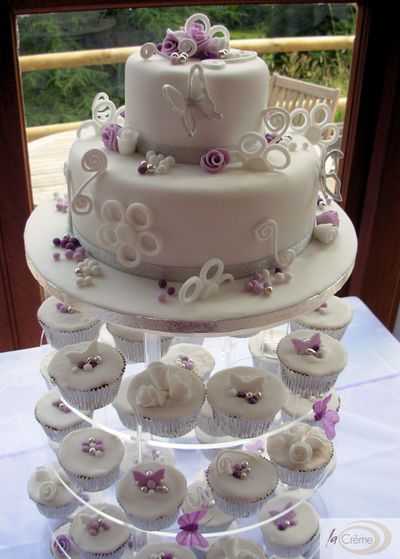 2 tier Wedding cake with matching cup cakes decorated in White Violet and 