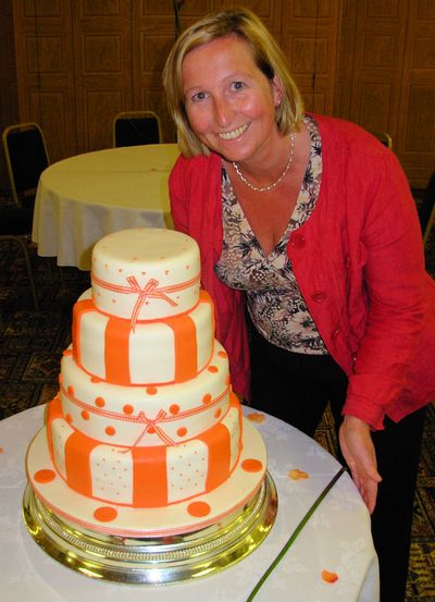 Sian with a 4 Tier Creme Orange Wedding Cake