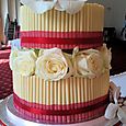 2 tier white cigarello wedding cake with roses