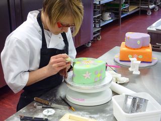 Mel icing a wedding cake