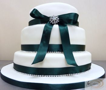 La Creme 3 tier ivory wedding cake with green ribbon and diamantes