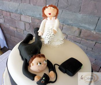 Wedding cake topper with bride, groom and X box
